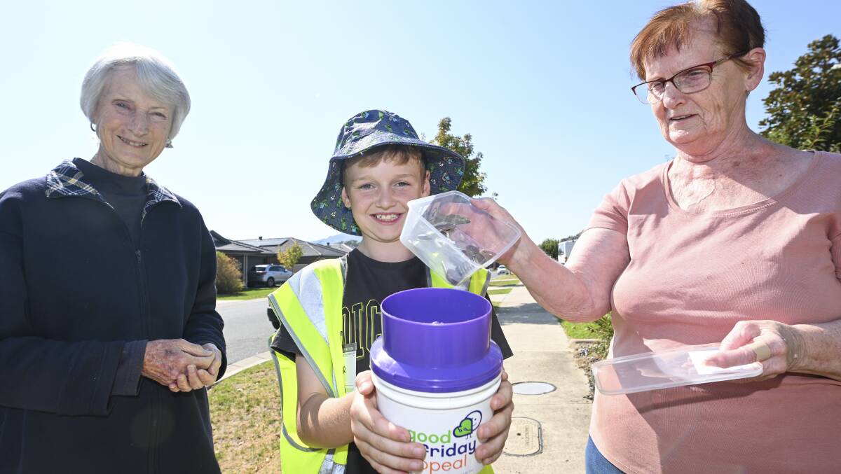 Volunteer Oscar Warnock, 9, was one of 165 helpers involved in the Good Friday Appeal in Wodonga. He is pictured with residents Ann Briggs and Beris Albon, whose coins contributed to a huge tally. Picture by Mark Jesser 