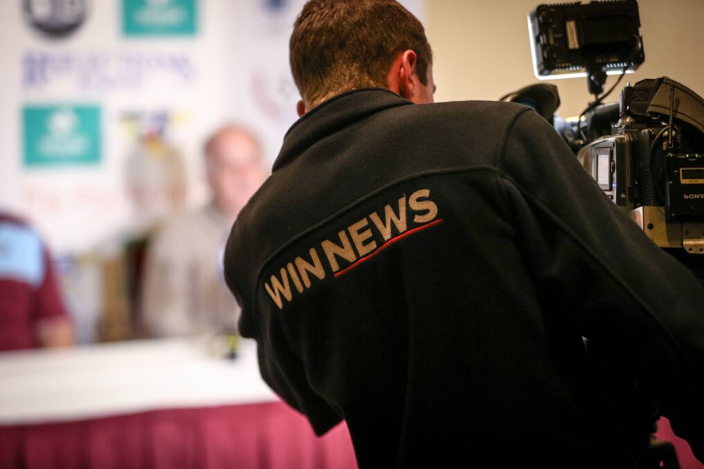 End of era: A WIN cameraman records a media conference on Thursday involving Border soccer figures. He along with other operators and journalists will lose their jobs with the bulletin ending. Picture: JAMES WILTSHIRE