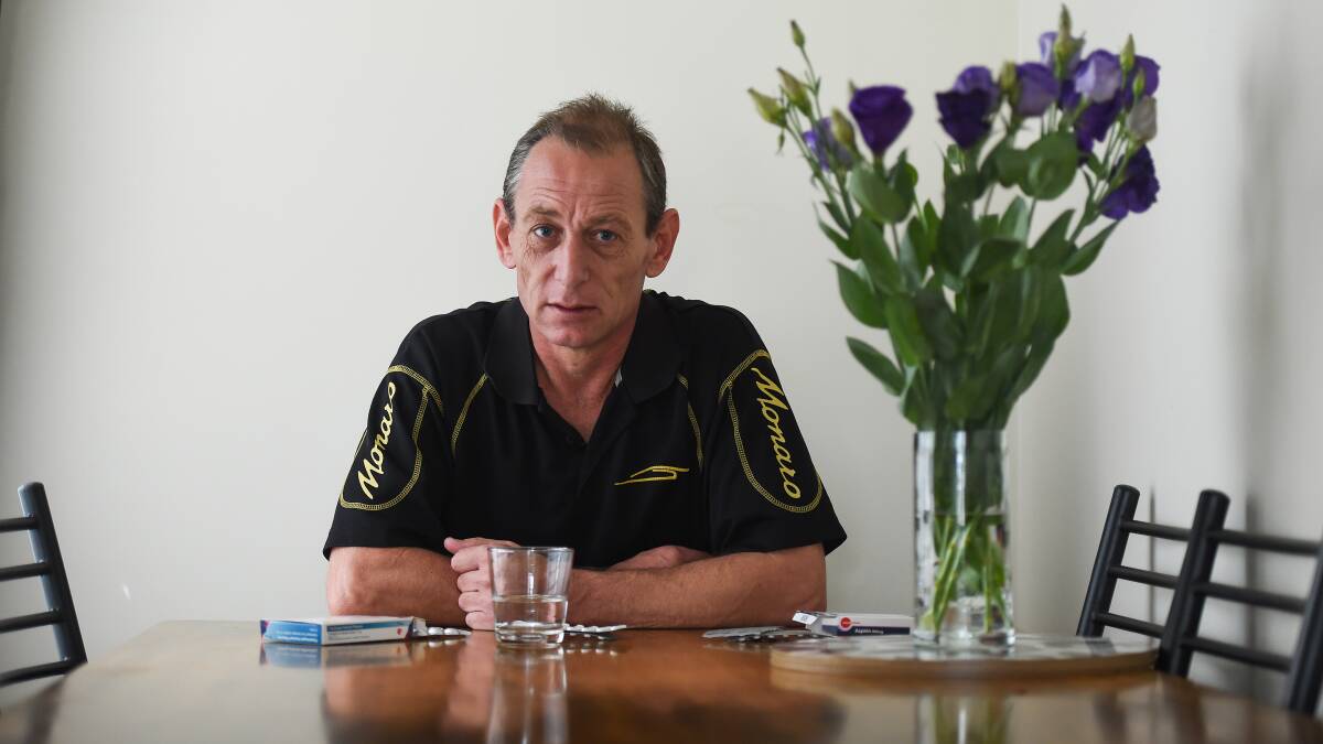 Angry: Danny Trim at his Wodonga home with medication he is taking to thin his blood after suffering heart attacks on Sunday that were diagnosed at Albury hospital. Picture: MARK JESSER