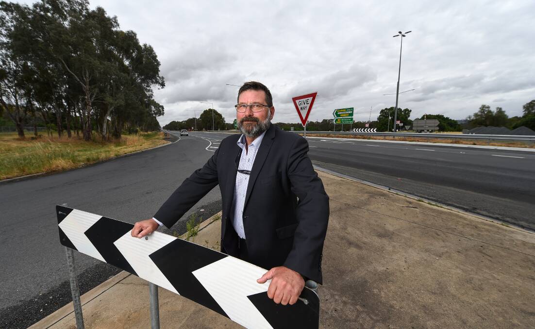Hitting out: Member for Benambra Bill Tilley at the Hume Freeway-McKoy Street intersection which has been the subject of debate over a promised flyover. 