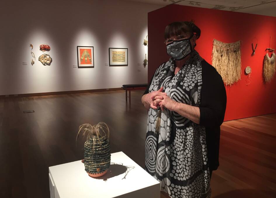 Proud moment: Artist Trish Cerminara with her vase which features echidna quills and emu feathers and is part of a display of Indgineous women's art.