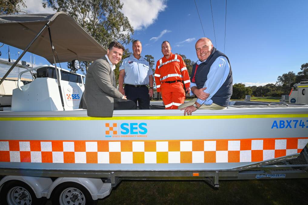 Starboard side: MP Justin Clancy joins SES duo Darren Hawke and Curtis Kishere and minister David Elliott in the new boat provided to the unit. Picture: MARK JESSER