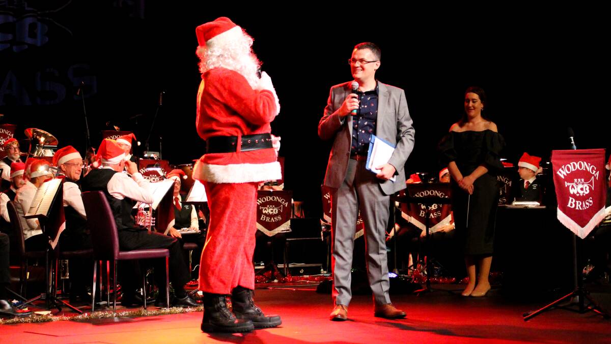 Take two: Santa Claus with Wodonga mayor Kev Poulton during last year's COVID-affected Carols by Candlelight. The same method of production will be used this year because of coronavirus.