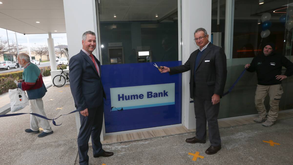 Blue ribbon occasion: Tony Whiting as chairman of Hume Bank opens the new Lavington branch in Wagga Road last year alongside the institution's chief executive Stephen Capello. 