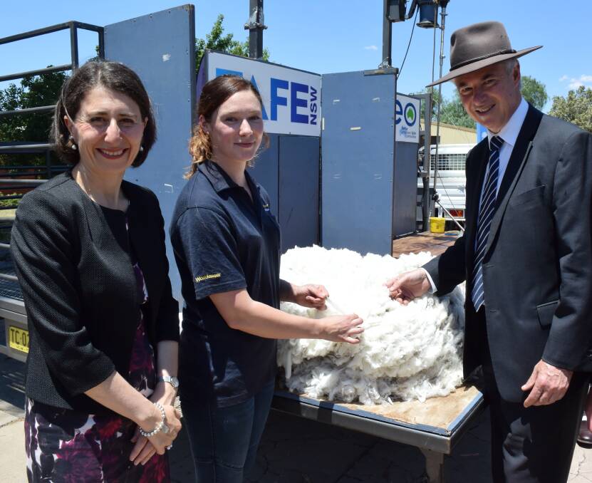 Golden fleece: Premier Gladys Berejiklian with wool classer Georgia Reeves and member for Albury Greg Aplin at Corowa yesterday for the TAFE announcement.