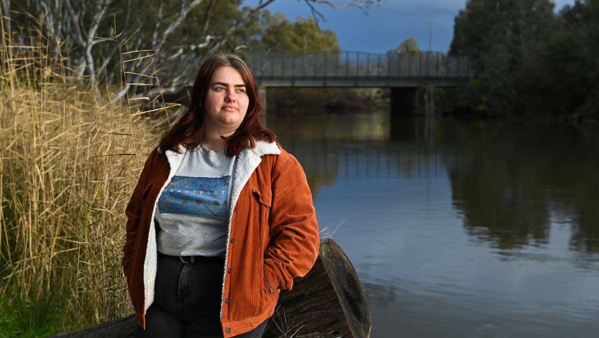Feeling trapped: Chloe Sargeant looks across the Murray River from Albury to Wodonga, a place she can visit for only limited reasons. Picture: MARK JESSER 