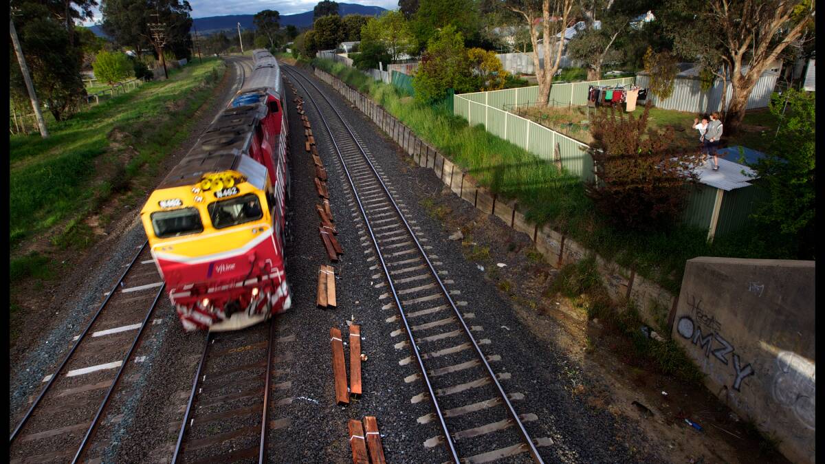 Go slow: A train passes through the North East line near Seymour. Copper wire between Seymour and Melbourne was stolen this week from train signals. 