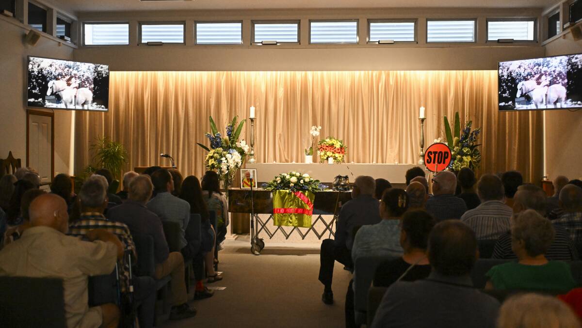 Brian Beach's school crossing supervisor outfit is draped over his coffin as the room was dimmed for a photographic tribute. Picture by Mark Jesser