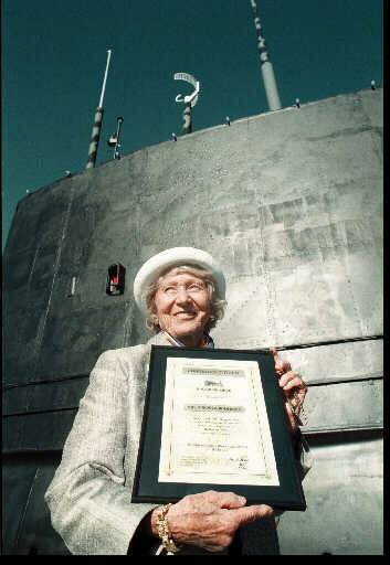 Proud day: Gundula Holbrook in 1997 in front of the HMAS Otway submarine with her certificate bestowing her with honorary citizenship of Holbrook.