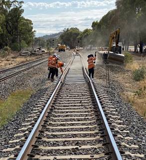 Rail gang: ARTC workers set in place new ballast to support sleepers and rails installed on a section of track at Barnawartha. Picture: ARTC
