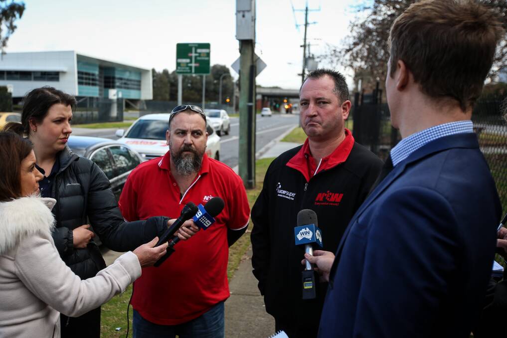 In the dark: National Union of Workers representatives Andrew 'Snags' Cameron and Neil Smith speak to the media in Albury about Murray Goulburn's sale of the Kiewa Country milk brand. Picture: JAMES WILTSHIRE