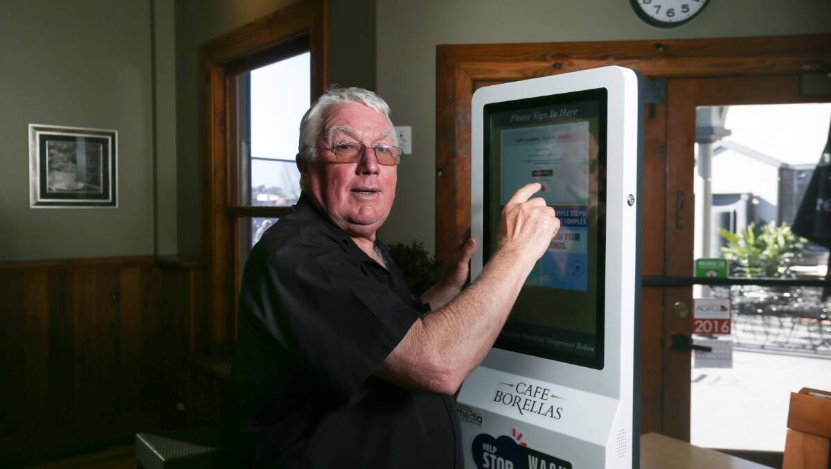 Hi-tech method: Cafe Borellas owner George Benyon demonstrates how a touchscreen can be used to record your visit to his East Albury eatery. Picture: TARA TREWHELLA