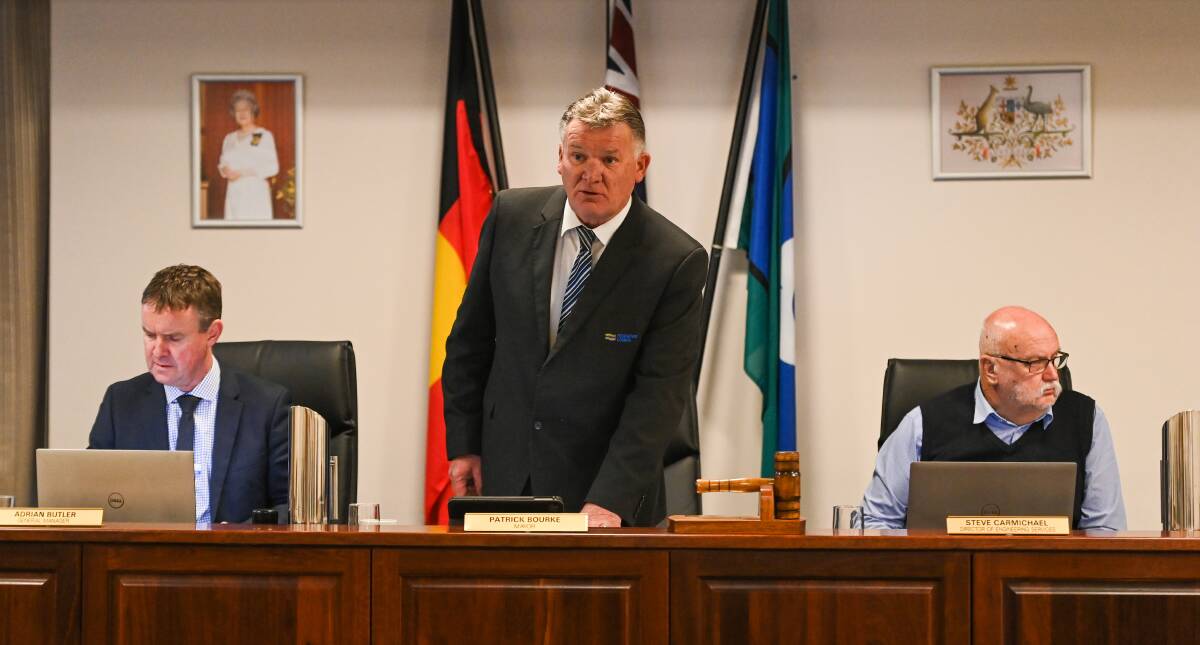 On his feet: Pat Bourke stands up during Tuesday's council meeting at Corowa. He is flanked by council's general manger Adrian Butler and engineering chief Steve Carmichael. Picture: MARK JESSER