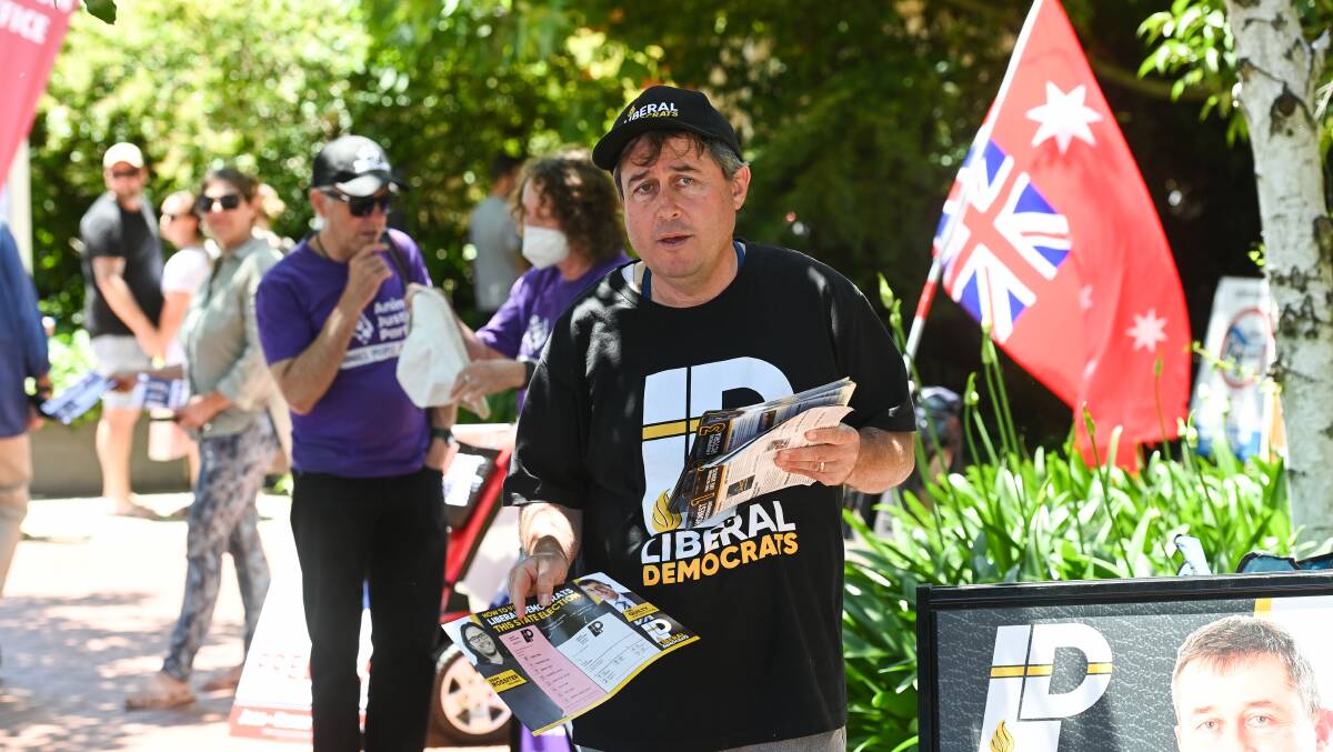 Upper House politician Tim Quilty distributes his how-to-vote pamphlets at the early voting hub in Wodonga on Friday. Picture by Mark Jesser.