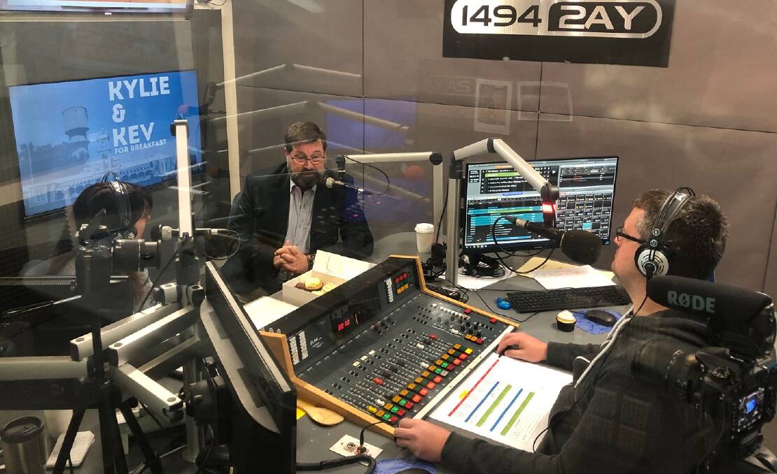 On-air: Bill Tilley speaks to Kylie King and Kev Poulton in 2AY's Albury studio before the arrival of the coronavirus. He is irked the pair will no longer host the breakfast show.