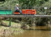 Flashback to when trains were operating on Holbrook's miniature railway and an engine is piloted across the Ten Mile Creek.