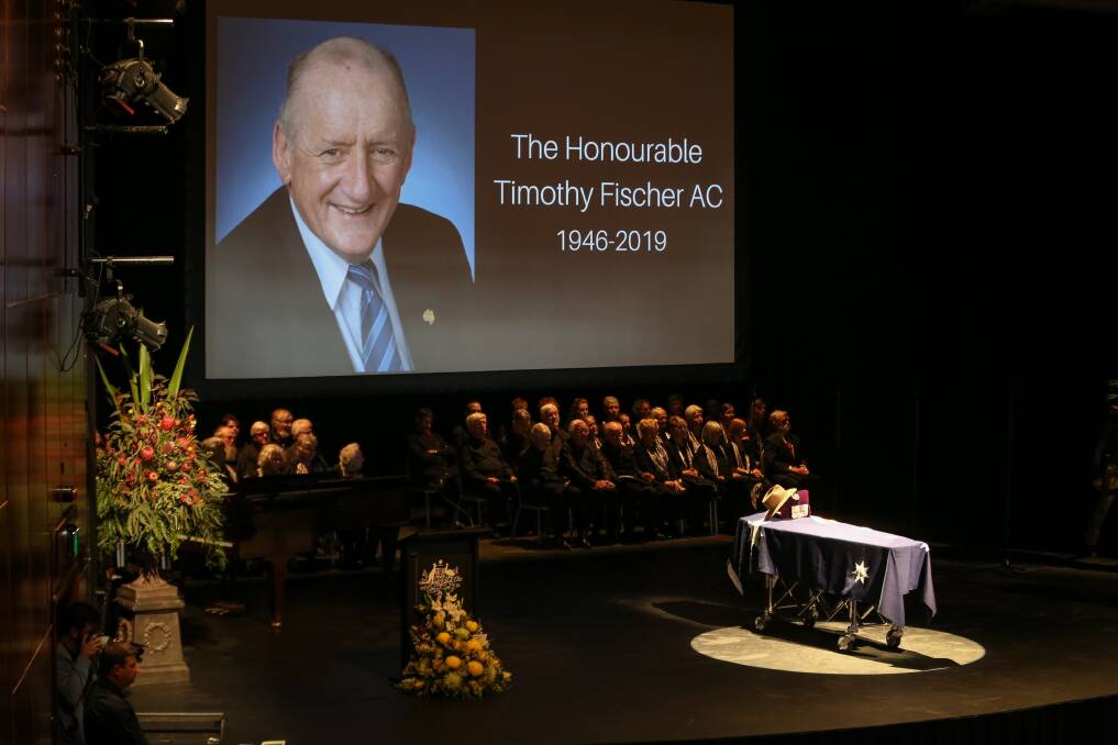 In the spotlight: Tim Fischer's coffin was centre stage below his portrait at his state funeral at the Albury Entertainment Centre. Picture: JAMES WILTSHIRE