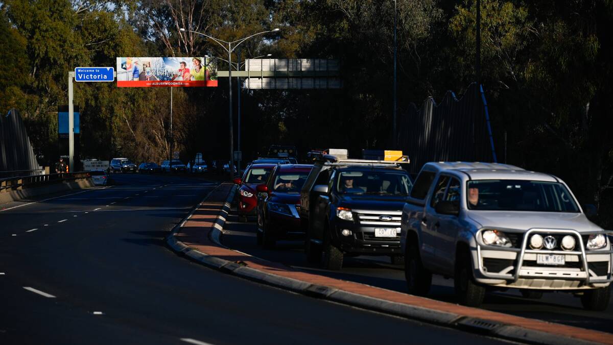 Cut back: Lines of traffic like this entering Albury's Wodonga Place checkpoint are expected to be less common with new permits, council chief Frank Zaknich has suggested. Picture: MARK JESSER