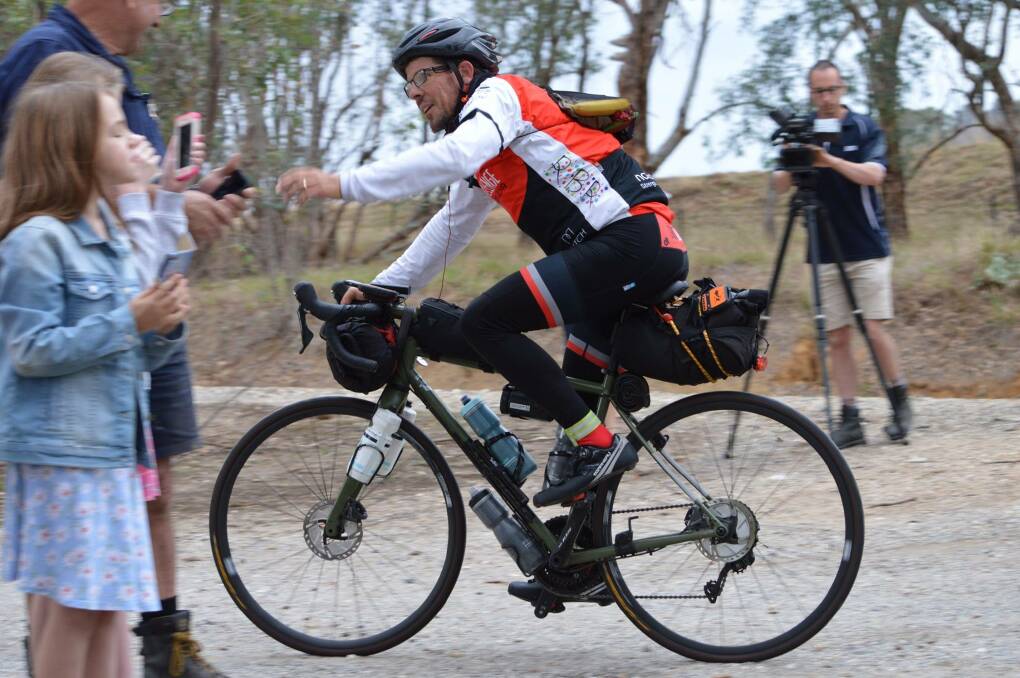 In action: Marty Cross rides through the North East during the Indian Pacific Wheel Race which saw him ride from Fremantle to Sydney earlier this year. The bike has now been stolen and Mr Cross is appealing for its return.