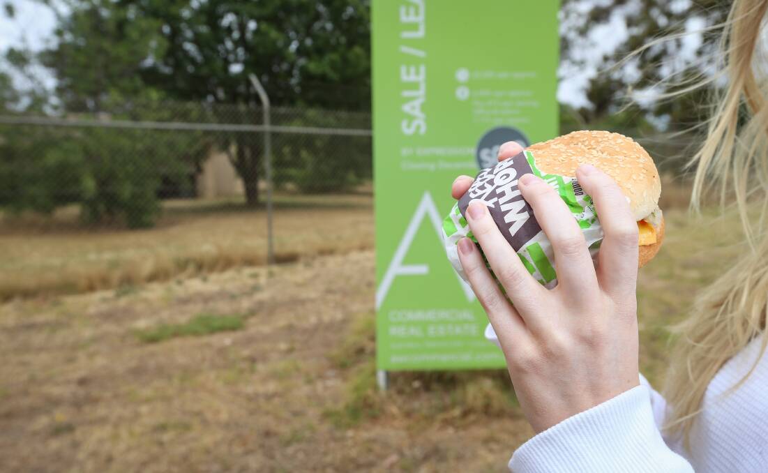 Combining: A consumer with an artificial meat Whopper outside the former form printing factory in Wodonga which will be used to make patties from plants. Picture: JAMES WILTSHIRE
