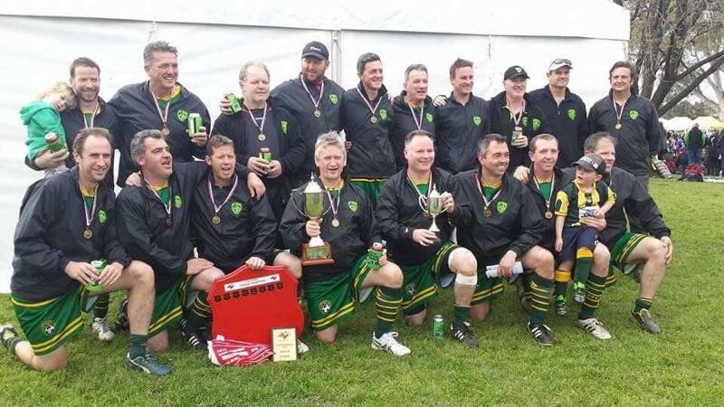 Much admired: Tony Iverson holds the big cup after a competition win with his over-35 St Pat's soccer team. A minute's silence marked his passing at the club's first match of this season and his number was retired from senior and over-35 grades.