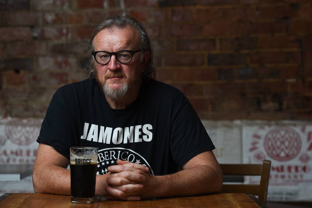 Glass half full: Beechworth restaurateur Michael Ryan is disappointed at restrictions continuing in regional areas but hopeful of bouncing back. Picture: MARK JESSER 