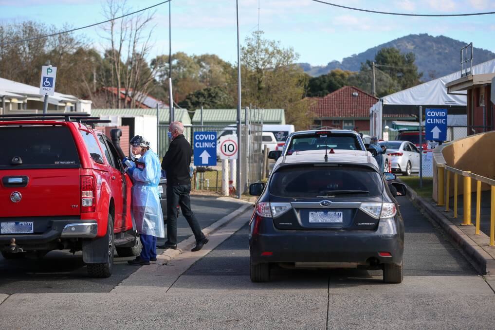 Long delays: Motorists queue up to be tested at Albury Wodonga Health's COVID examination hub near Wodonga hospital on Tuesday in response to Victorian border entry conditions. Picture: JAMES WILTSHIRE