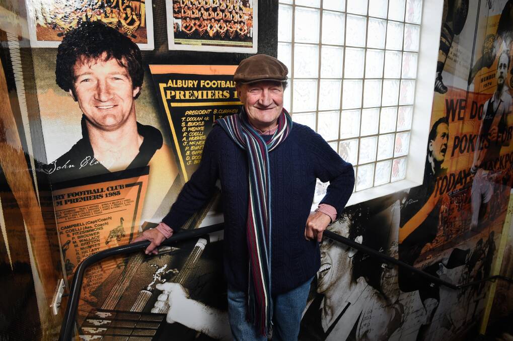 Glory days: Jack Clancy stands next to a portrait of himself, as a young man, in the Albury Tigers Club in 2016. Picture: MARK JESSER