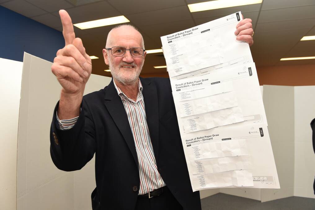 Print handicap: Albury councillor David Thurley holds a ballot paper before the 2016 election. Increased costs for the voting forms are a factor in higher election costs.
