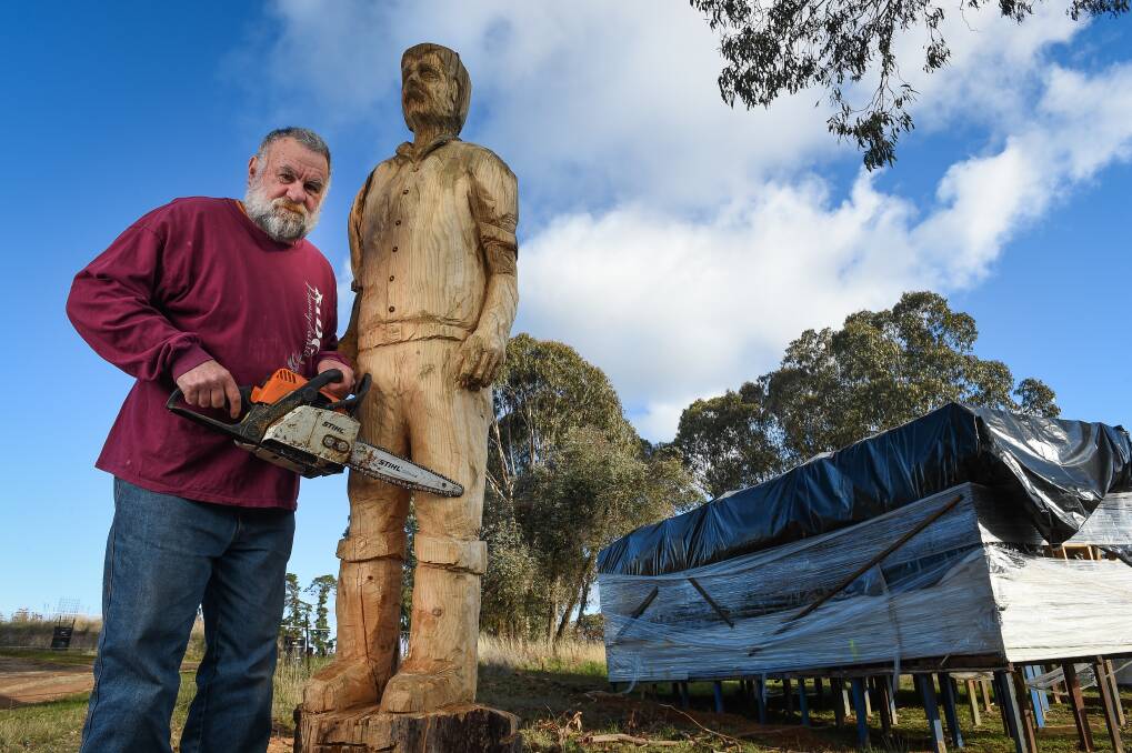 Cut out: Kevin Duffy with his carving of actor Michael Caton as Darryl Kerrigan. Picture: MARK JESSER