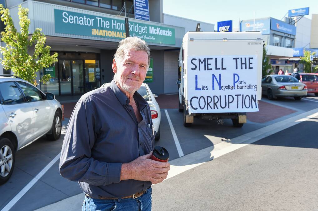 Making a point: Glenn Wilson with his protest sign on the back of his vehicle outside Bridget McKenzie's office. Picture: MARK JESSER