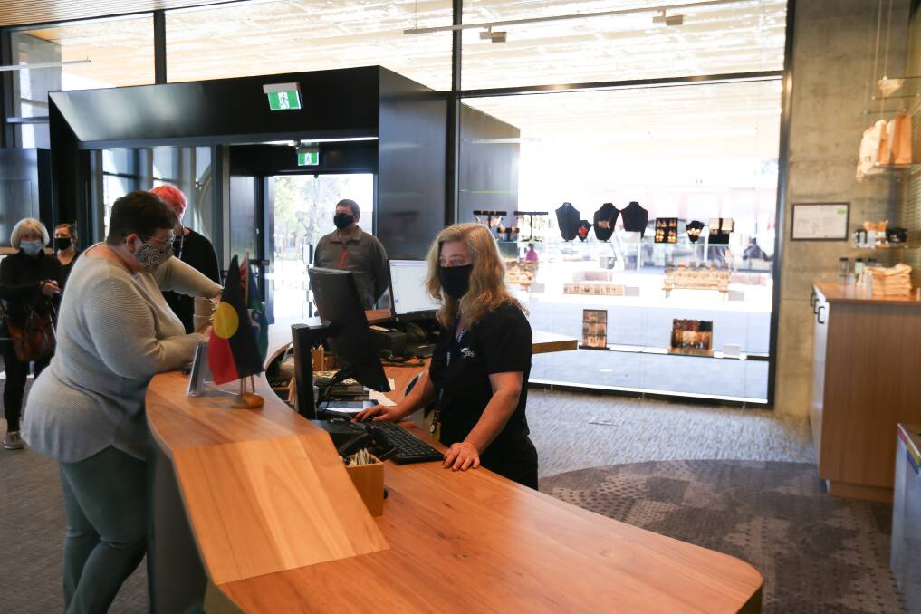 Wooden character: A fine timber counter is a feature at the new library's reception and loans area. Picture: TARA TREWHELLA