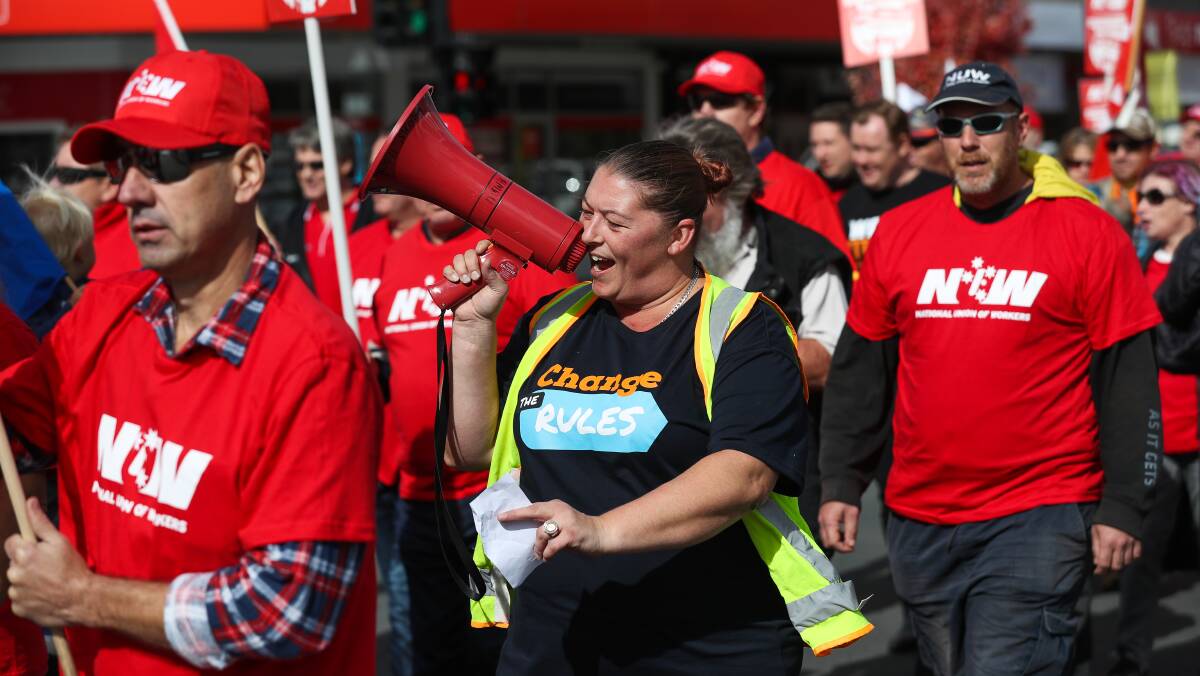 Hear our message: North East and Border Trades and Labour Council secretary Naomi Diehm chants into her megaphone during a lunchtime union march in Wodonga's High Street yesterday. Picture: MARK JESSER