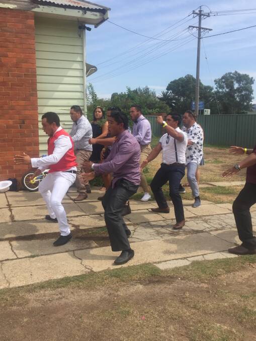 Special moment: Charles Davis, dressed for the races in a red vest, leads his family in a  haka in a tribute to those killed in Christchurch last week.