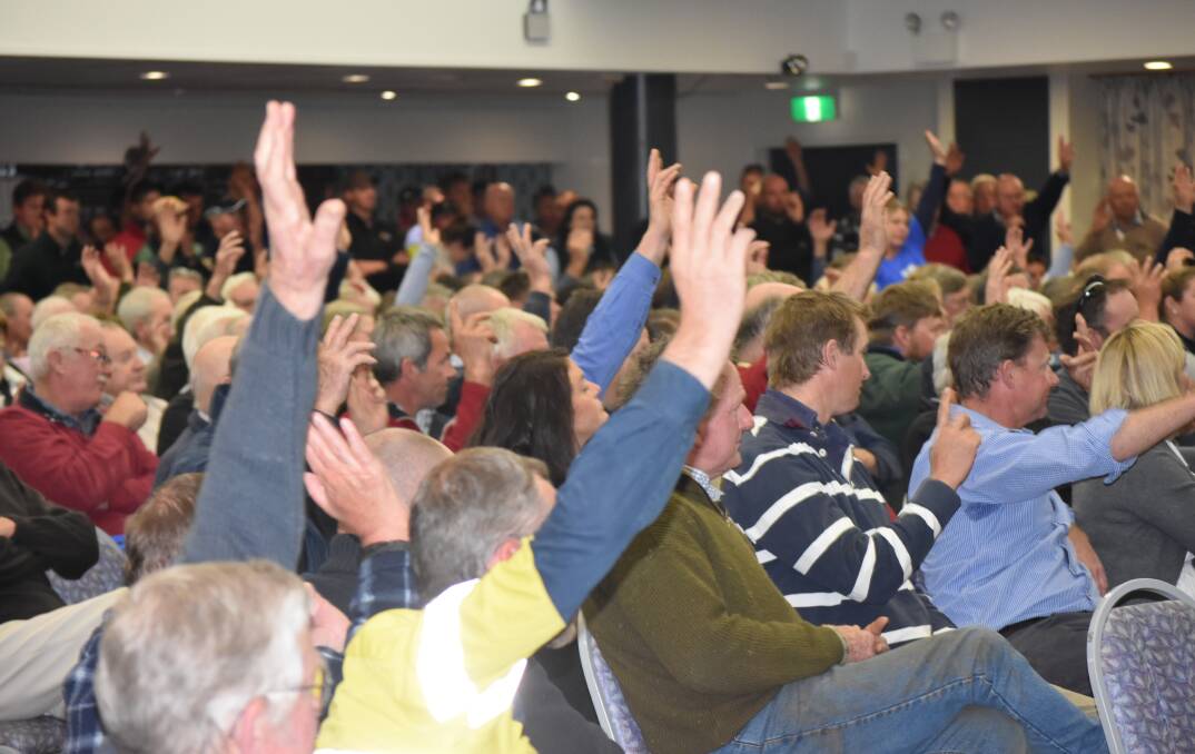 Hands up: Irrigation farmers back a motion calling for action at Monday's Speak Up rally at Deniliquin RSL Picture: COURTESY OF SPEAK UP