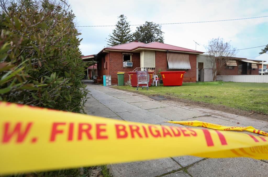 Deceptively normal: Fire service tape appears to be the only clue to the damage suffered when this house in North Albury had flames rip about it on Sunday night. Picture: JAMES WILTSHIRE