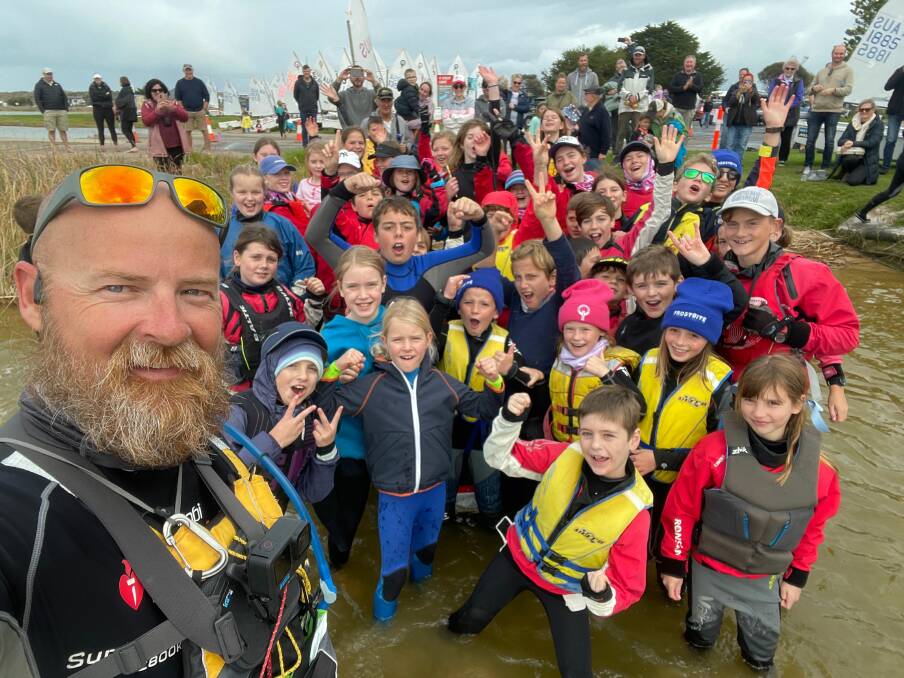 Bravo. Young admirers join Albury photographer Peter Charlesworth's selfie at the Goolwa Aquatic Club to mark the completion of his remarkable passage along the Murray River.