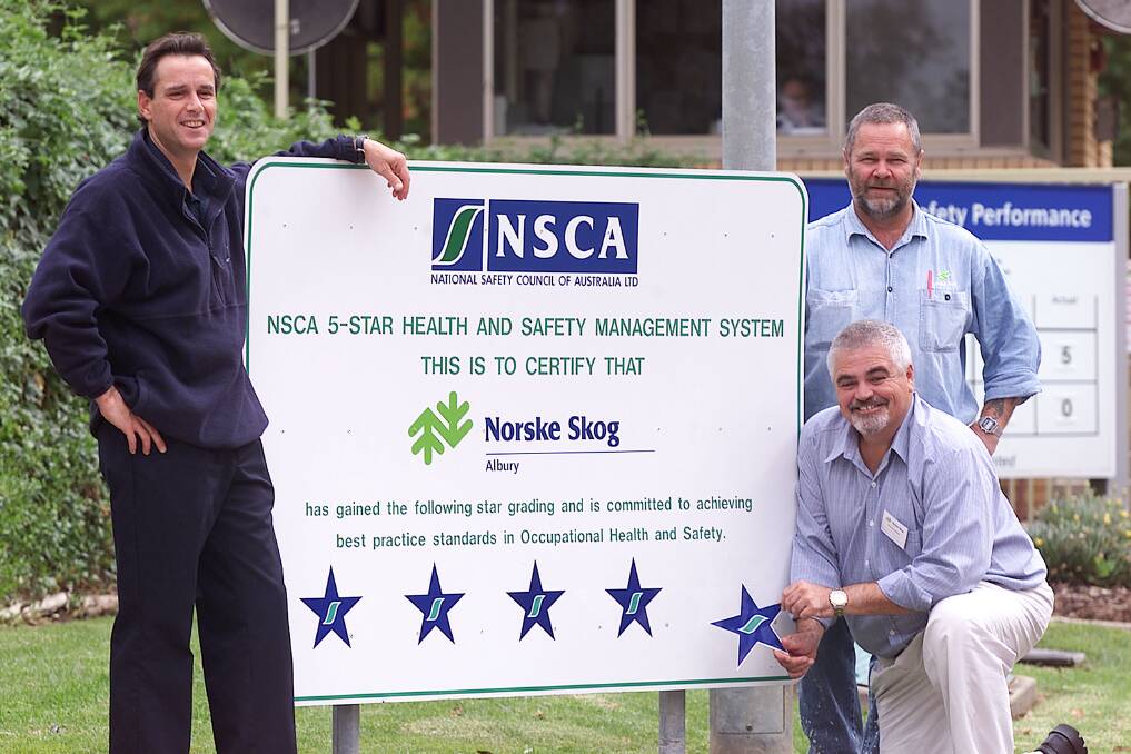 Flashback: Norske Skog employees Noel Johnston and Eric d'Olce join National Safety Council of Australia's Martin Baker (kneeling) to mark the Ettamogah mill reaching five-star certification for health and safety management in 2003. 