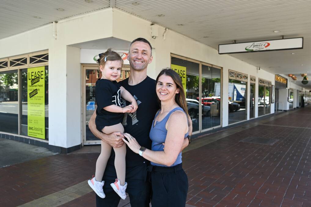 Gearing up: Kade and Carly Brown with their daughter Evie, 3, outside the shopfront, on the corner of Dean and David streets, that they will turn into Grill'd Albury. Picture: MARK JESSER