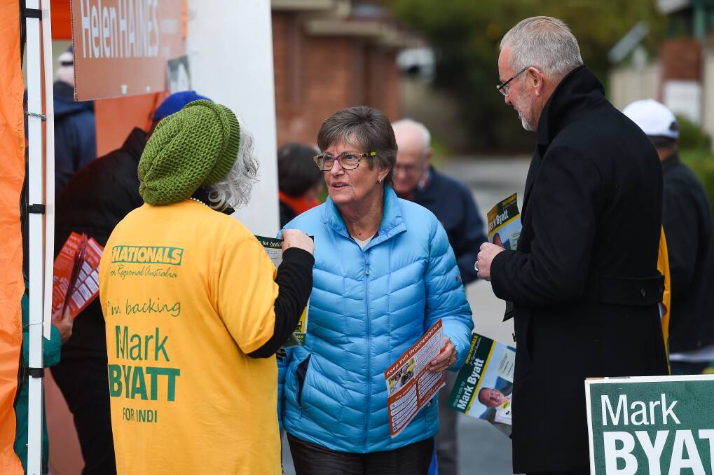 One of many: Wodonga's Louise Farrar voted early as it was "convenient". She is with a Nationals helper and candidate Mark Byatt. Picture: MARK JESSER 