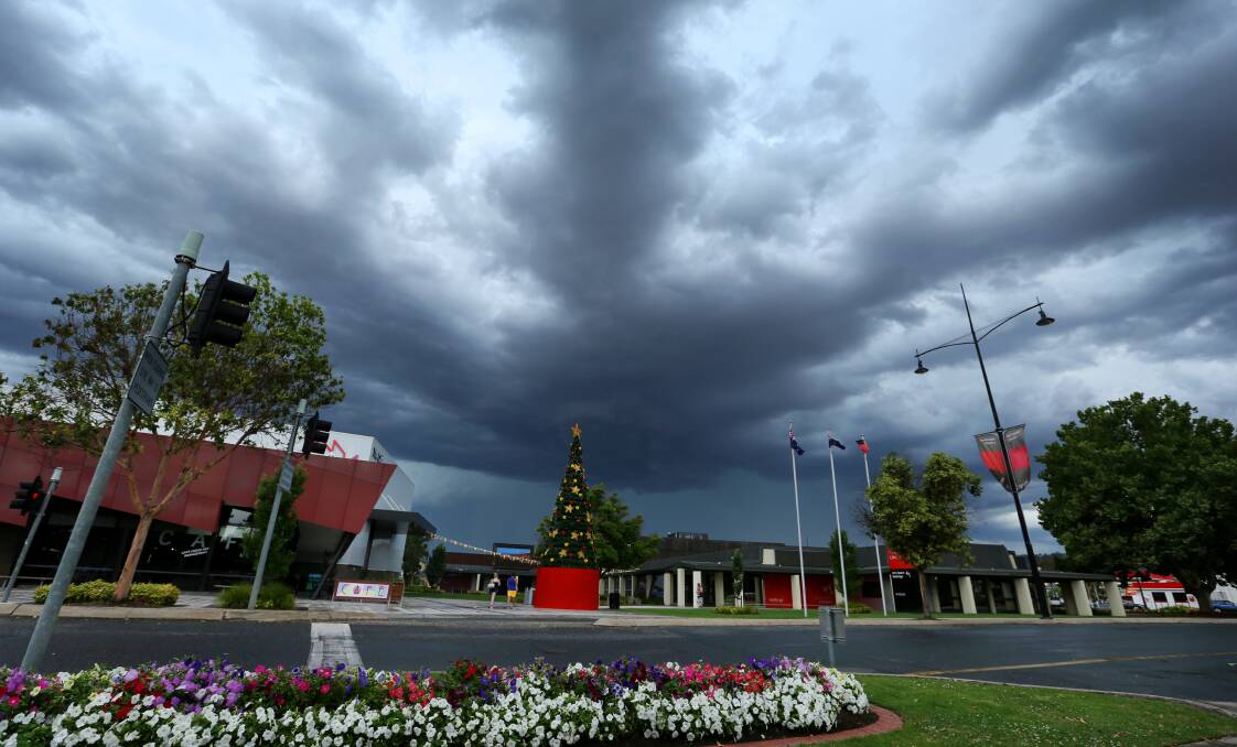 Flashback: Storm clouds loom over Wodonga library and The Cube in December 2014. At the same time this year the library should be in the process of being demolished, according to the city's council. 