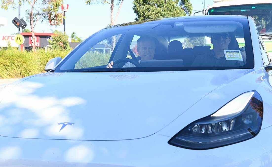 Powered up: Former Labor leader Bill Shorten pilots a Tesla electric vehicle around Wodonga yesterday during his visit to the North East. Pictures: MARK JESSER