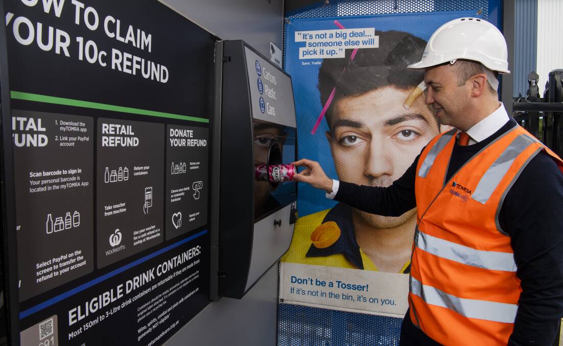Look at this: NSW Environment Minister Matt Kean puts a can in a recycling machine as part of the state's container deposit scheme. His colleague Ben Franklin pointed to the scheme to defend the government's green record as Coalition MPs voted against a plastic bag ban.