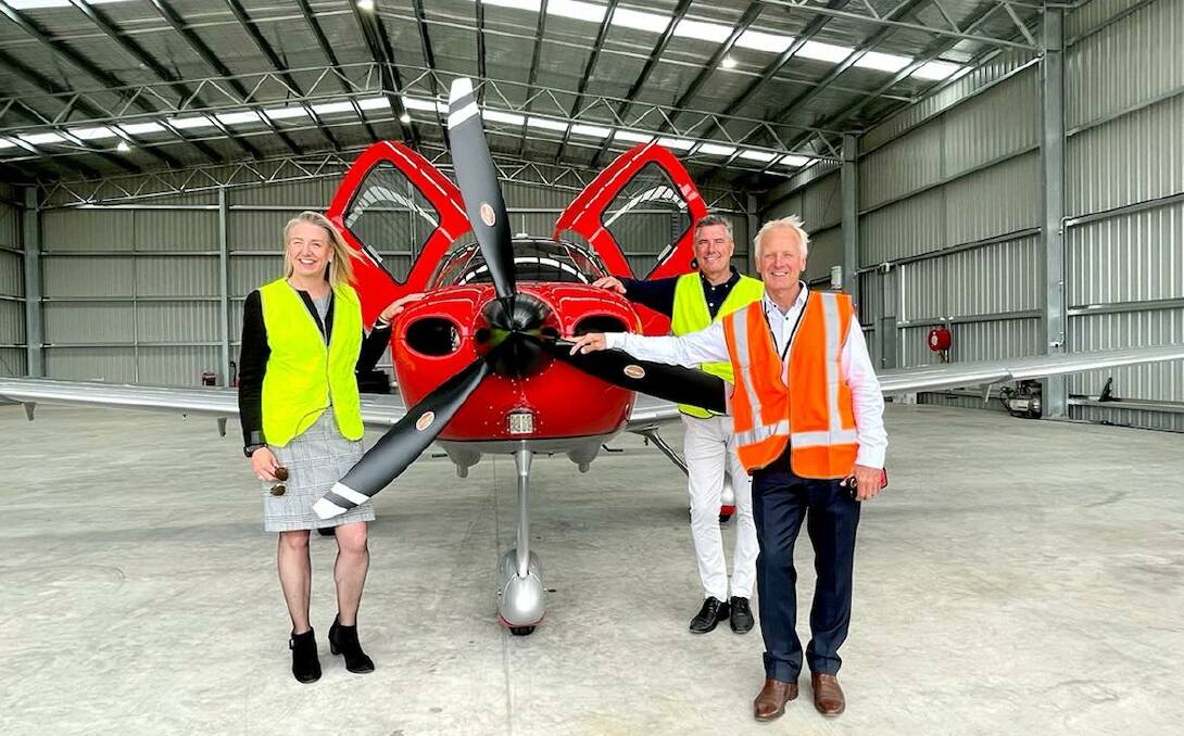 Take off: Senator Bridget McKenzie, Wangaratta mayor Dean Rees and hangar tenant Phil Ross in the new building which can house multiple planes and helicopters.