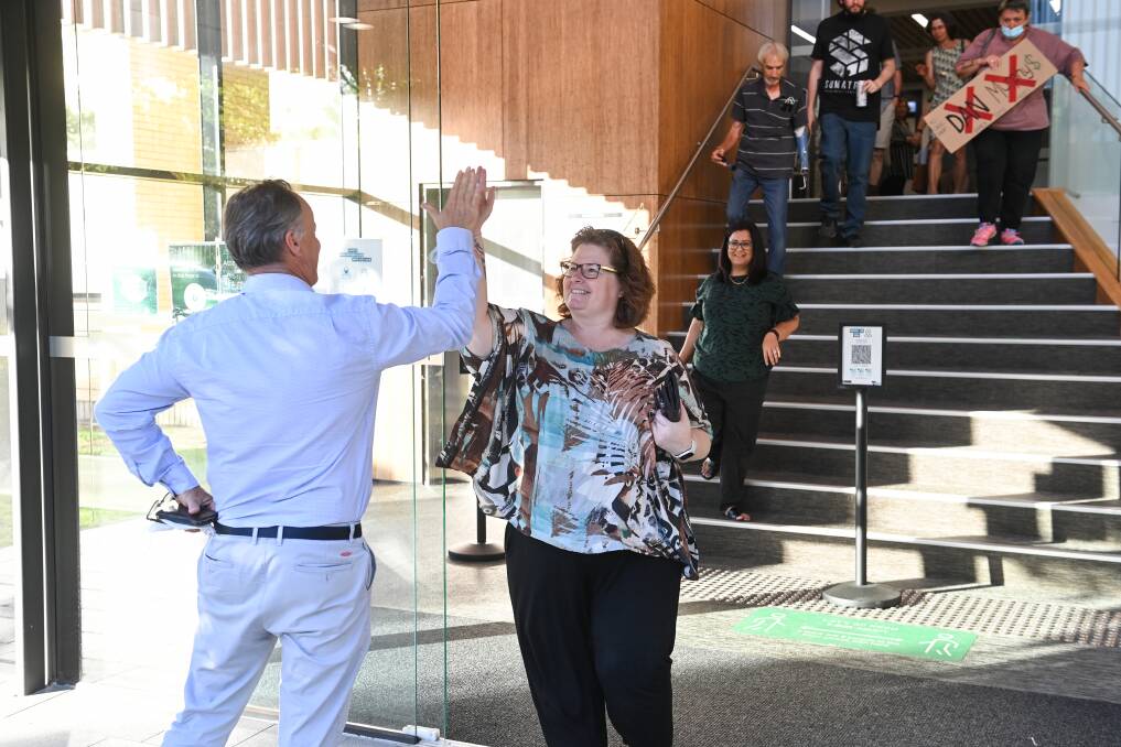 Flashback: A delighted Bobbi McKibbin gives former Wodonga Council director Michael Gobel a high five as she leaves the city's Hovell Street headquarters in the walke of the city's master plan decision in December.