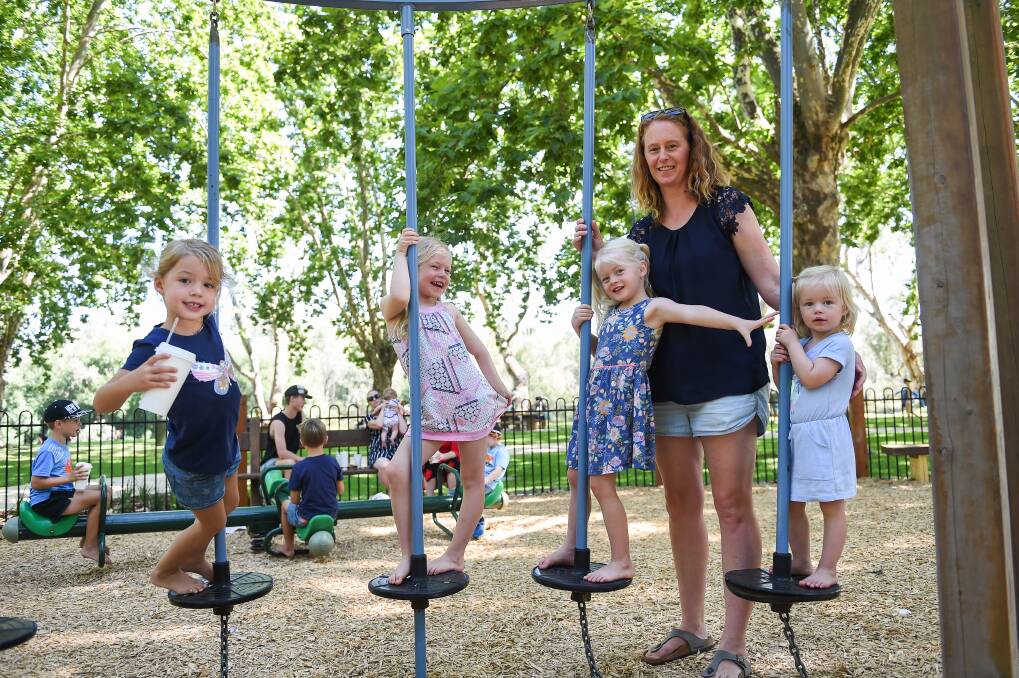 Fun in the sun: Sarah Harris with Ella Way, 4, and her children Evie Harris, 5, Belle Harris, 3, and Peggy Harris, 1, at the recently enclosed Noreuil Park playground. Picture: MARK JESSER