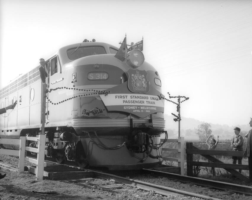 History recalled: The engine hauling the inaugural Southern Aurora journey from Sydney to Melbourne bursts through a commemorative string to mark its arrival in Wodonga on April 13, 1962. A garland of waratahs and pink heaths, the NSW and Victoria floral emblems, were burst by the locomotive.