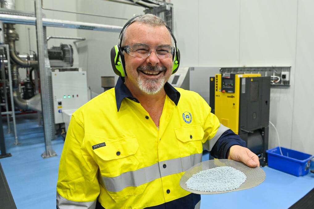 End product: Extruder Alistair Davies with the resin granules after they have been formed. Part of his job is to test their strength for use in new PET bottles. Picture: MARK JESSER