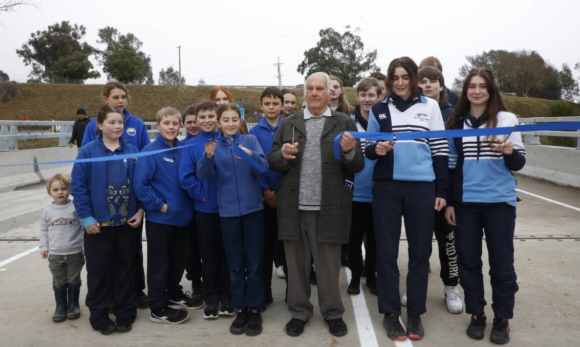 Tiny Archie Davies, 3, of Towong, snuck in to stand alongside Corryong students and retired farmer John Whitehead as the new bridge was opened. Picture by The Corryong Courier