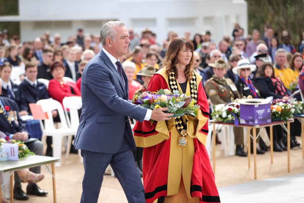 Paying tribute: Albury Council chief executive Frank Zaknich and mayor Kylie King in her official regalia place a wreath at the city's war memorial. Picture: JAMES WILTSHIRE